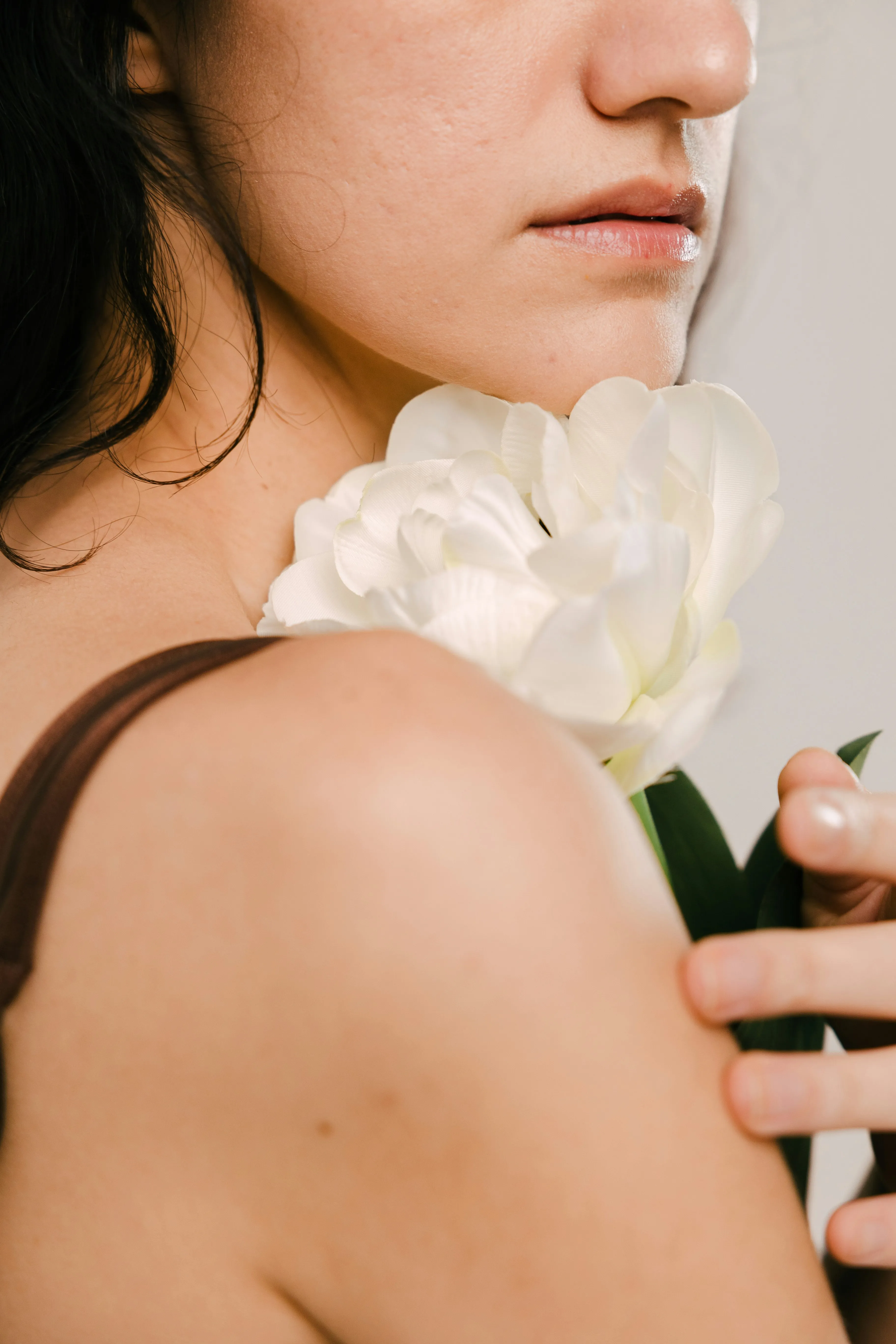 Woman holding a white flower